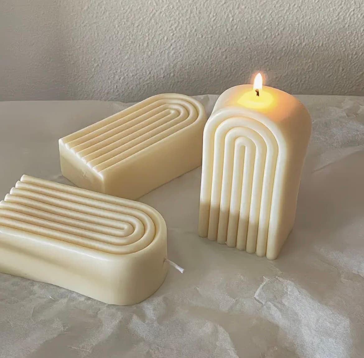 Concentric arch candles in tan and cream, hand-poured in soy wax