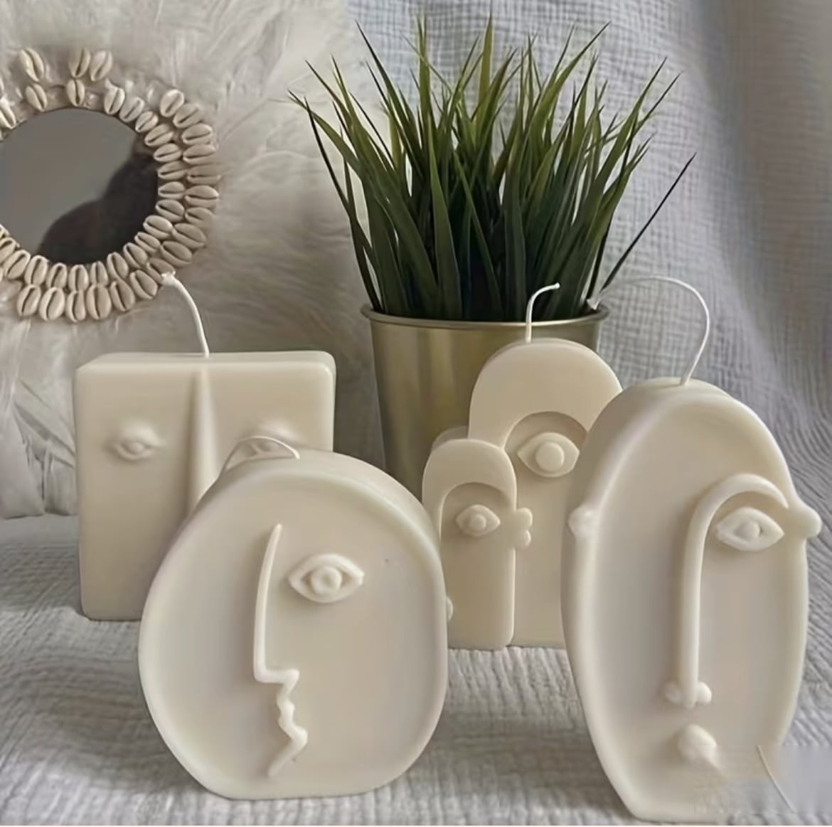 Modernist face candles, a cluster