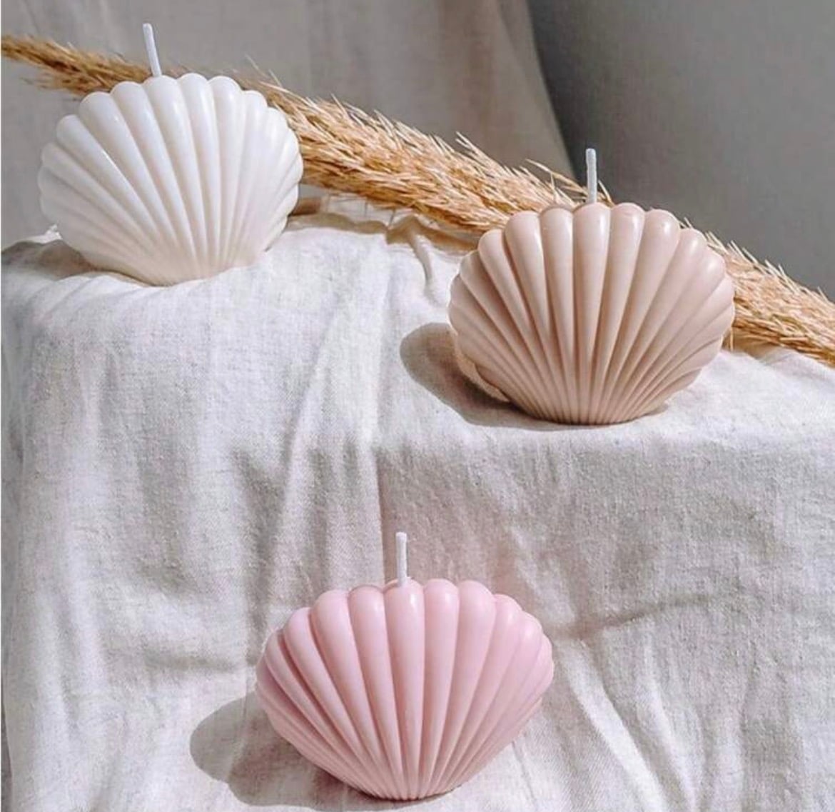 Candle beside ribbed ceramics