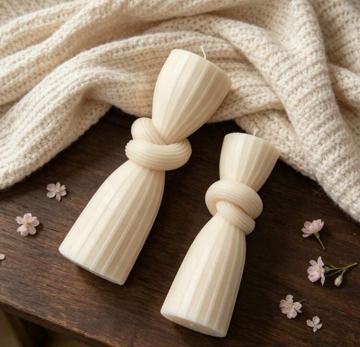 Éluvane candle collection - sculptural pieces in cream wax on marble