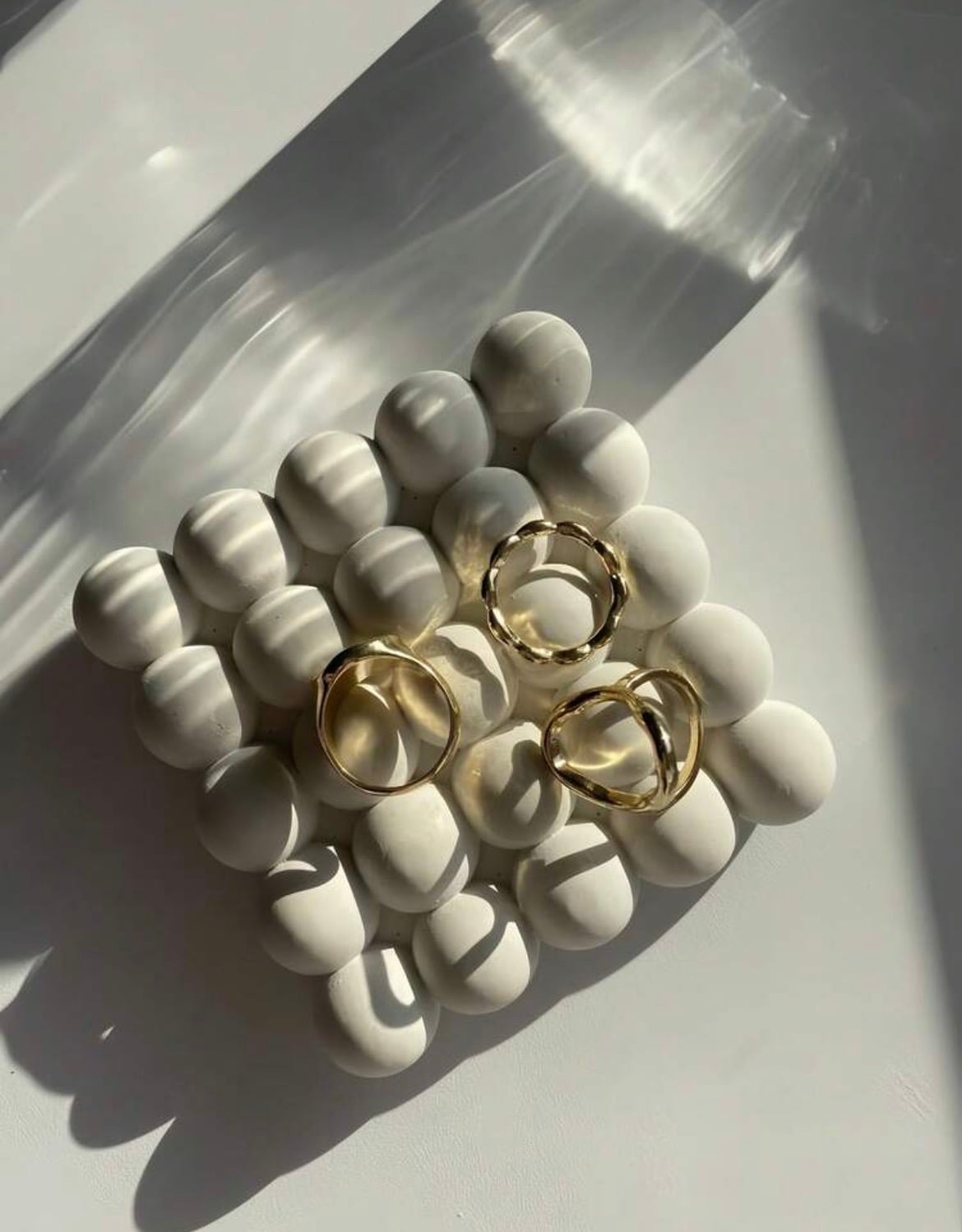 Bubble ring holder, a square cluster of cast plaster spheres