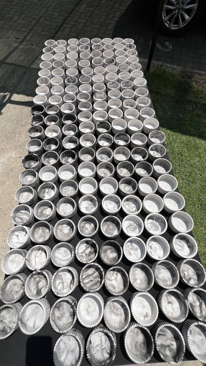 160 hand-cast marble fluted tumblers drying before they are filled with candles
