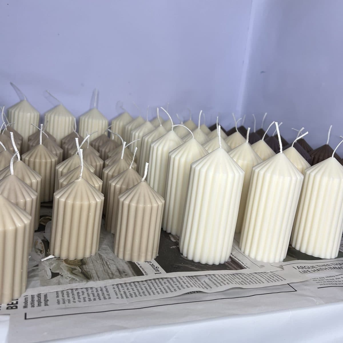 Fluted pillar candles in cream and taupe, hand-poured in a batch