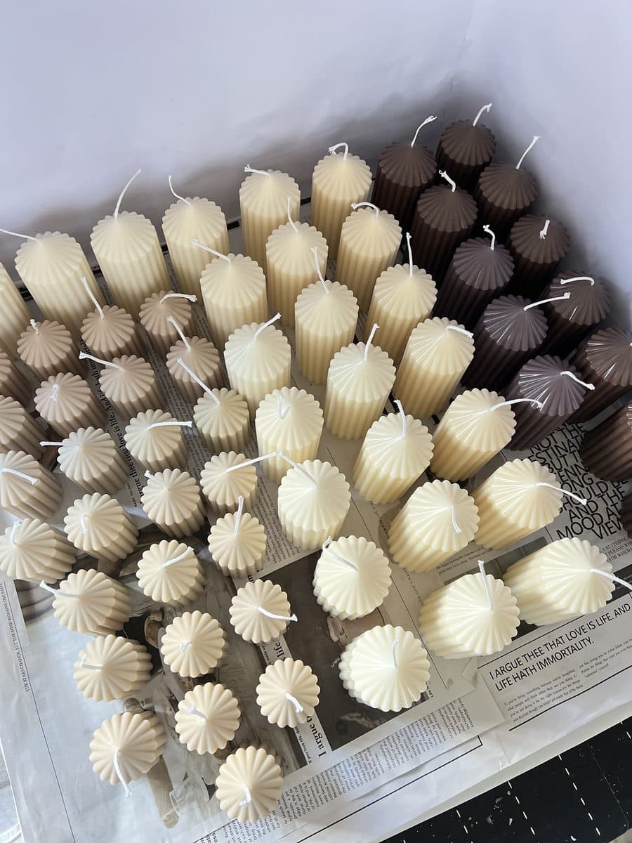 Fluted pillar candles in cream, taupe and chocolate brown, seen from above
